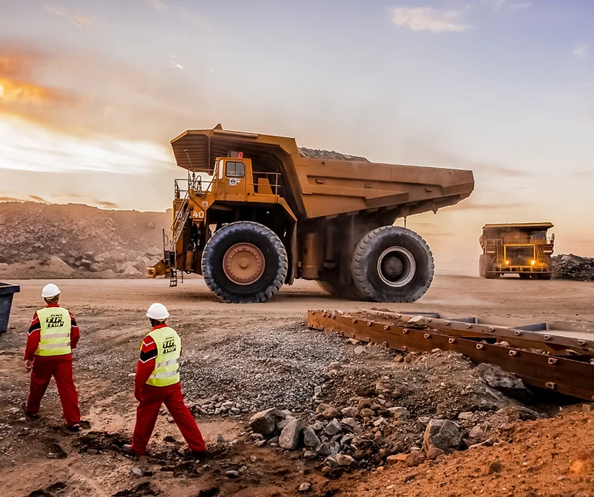 Haul trucks and crew at an open-pit mine